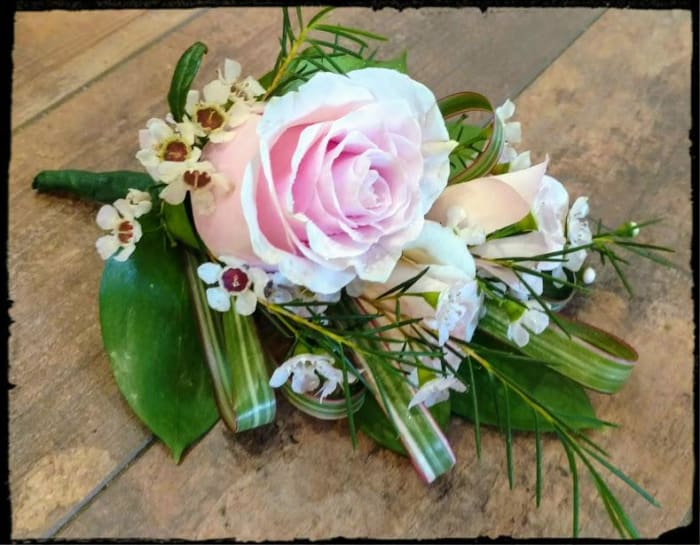 PINK ROSES AND TROPICAL FOLIAGE BOUTONNIERE