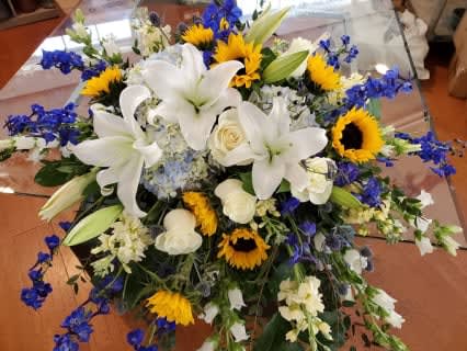 Lilies, Sunflowers, Delphiniums casket spray