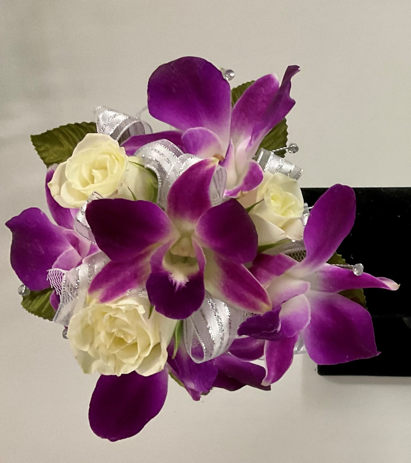 Purple orchid and white roses corsage