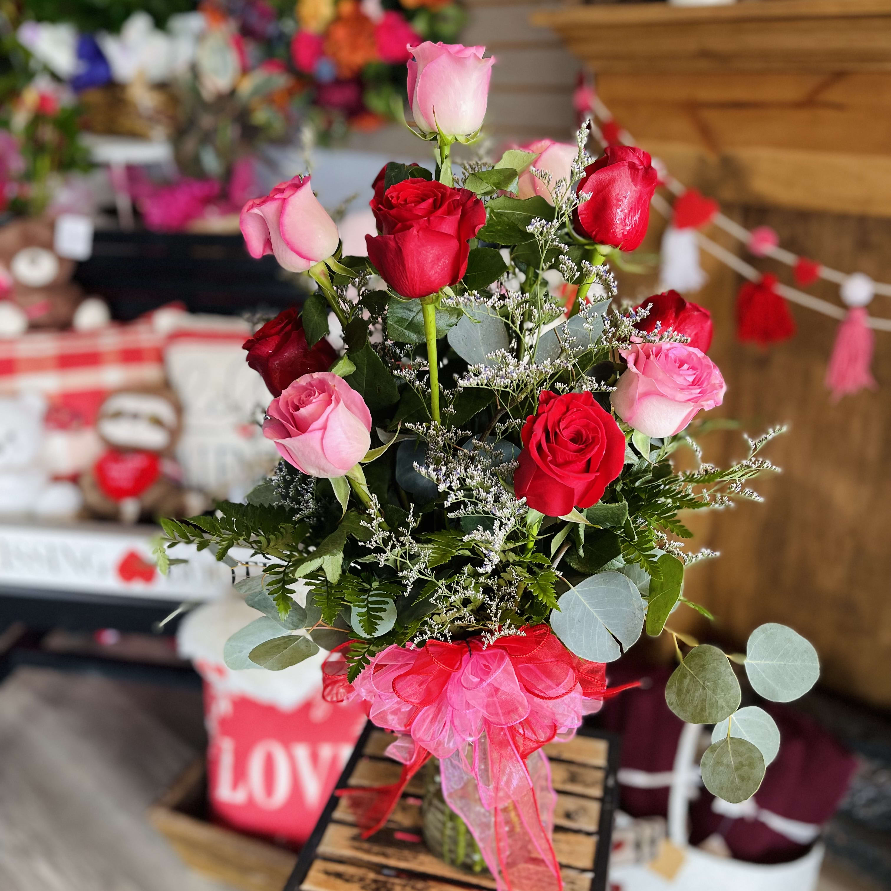 Dozen red and pink roses in a vase