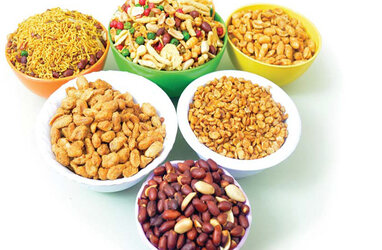 A side view of a plate of figs and berries.