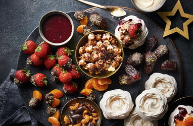 A side view of a plate of figs and berries.