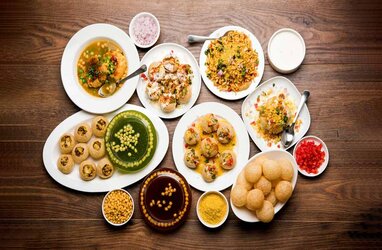 A side view of a plate of figs and berries.