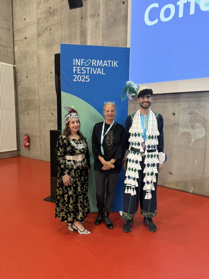 Adil wearing traditional Assyrian clothing under AI ART Gallery Informatik Festival 2025