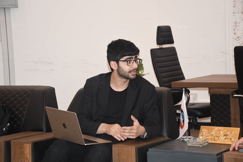 Adil explaining competition requirements to Kossay Alahmady (University of Mosul president)