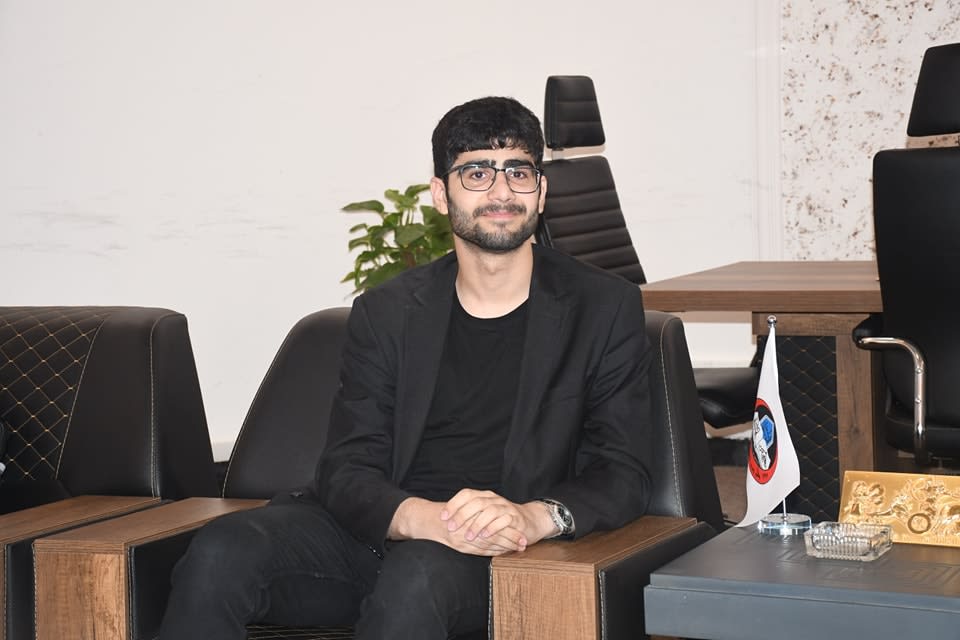 Adil sitting during interview with Kossay Alahmady (University of Mosul president)