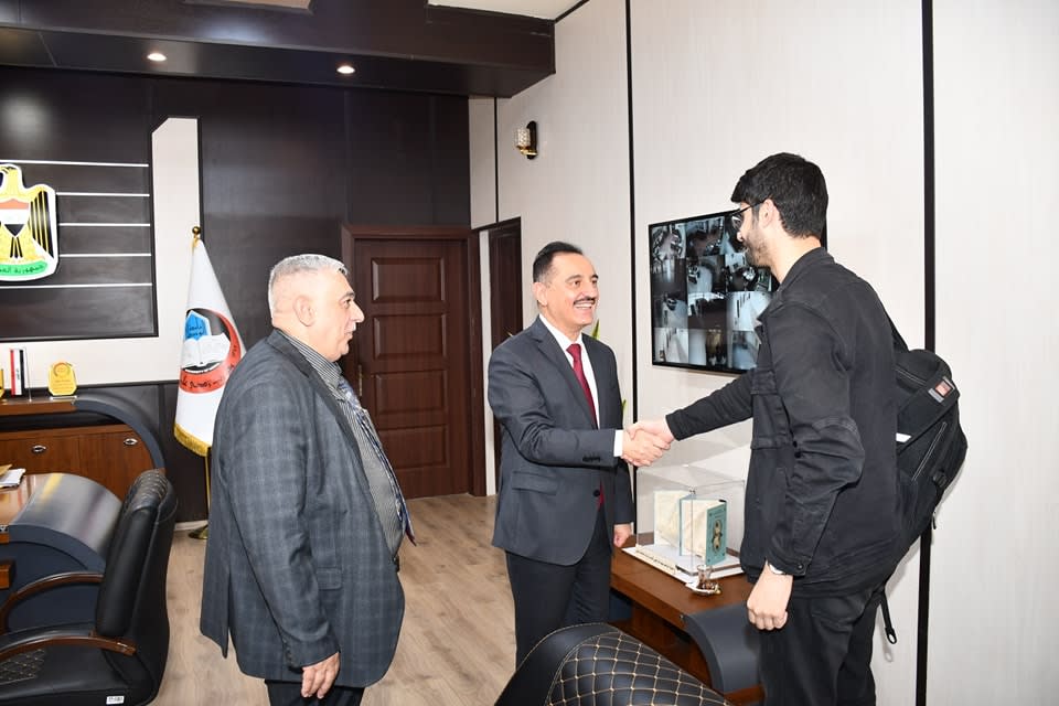 Adil shaking hands with Kossay Alahmady university president