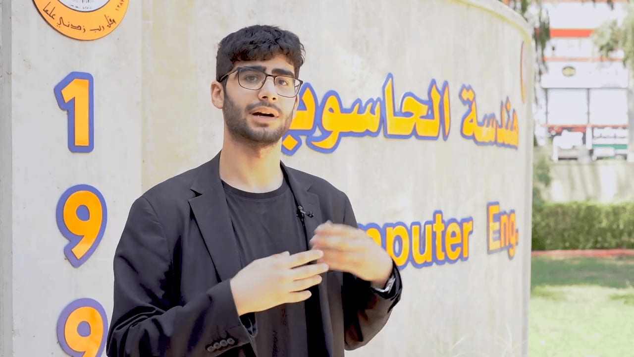 Adil talking to inteviewer about programming experience in University of Mosul press interview