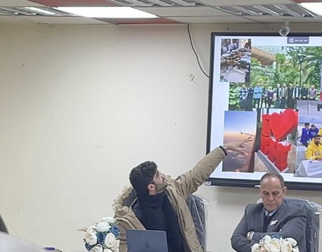 Adil pointing at slides during success story presentation