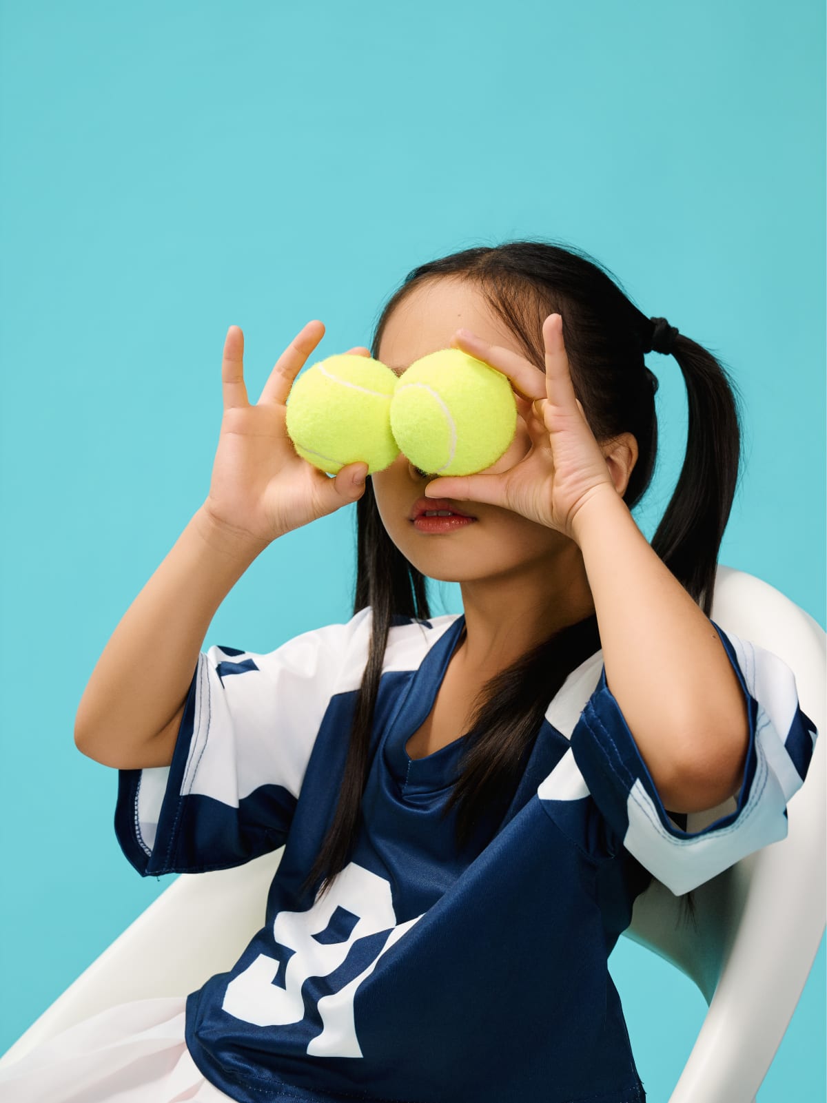 Two tennis balls held up over the eyes like goggles.