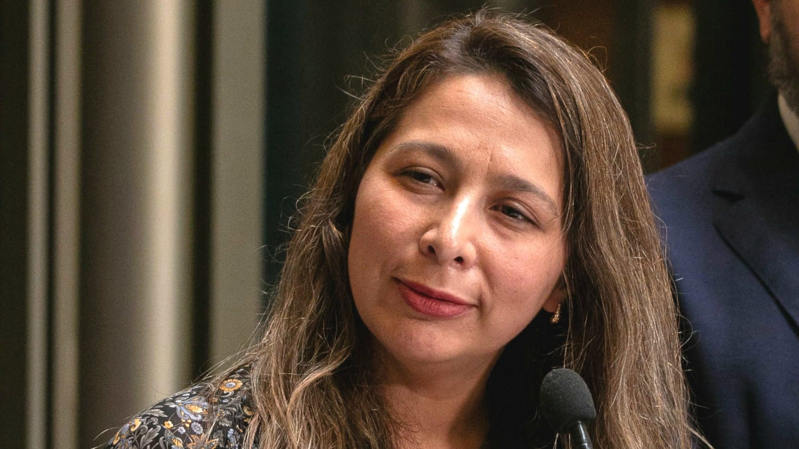 La diputada Paulina Muñoz habla ante un micrófono en una conferencia de prensa