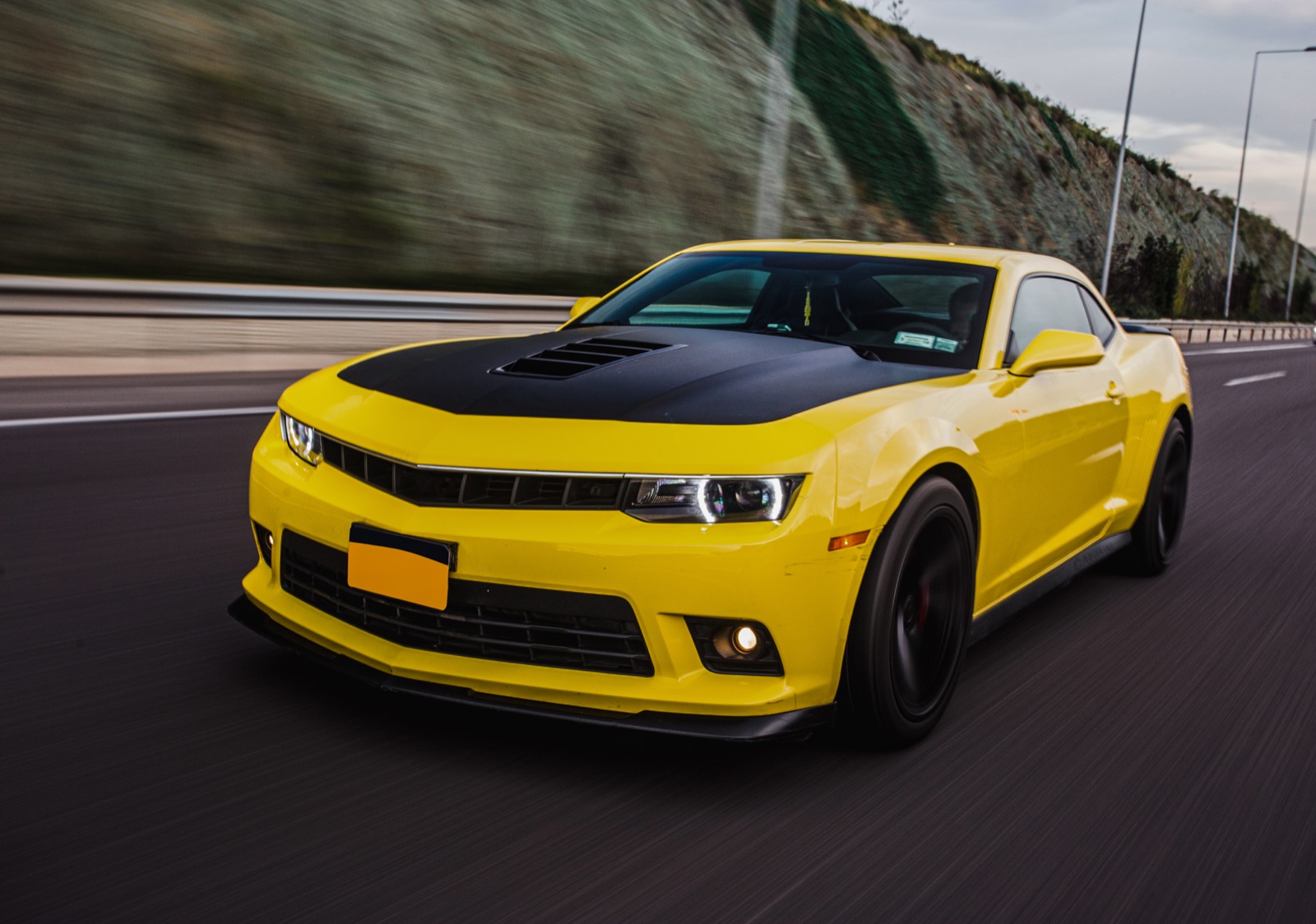 Yellow sport car on road