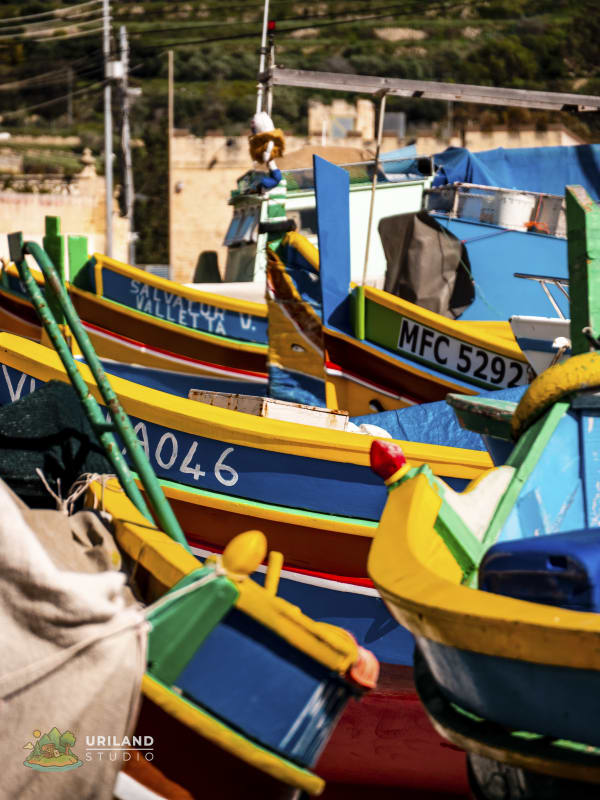 A row of luzzu boats moored side by side