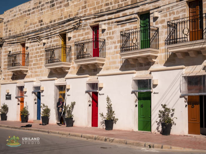 A row of traditional fishing village houses with colourfully painted doors