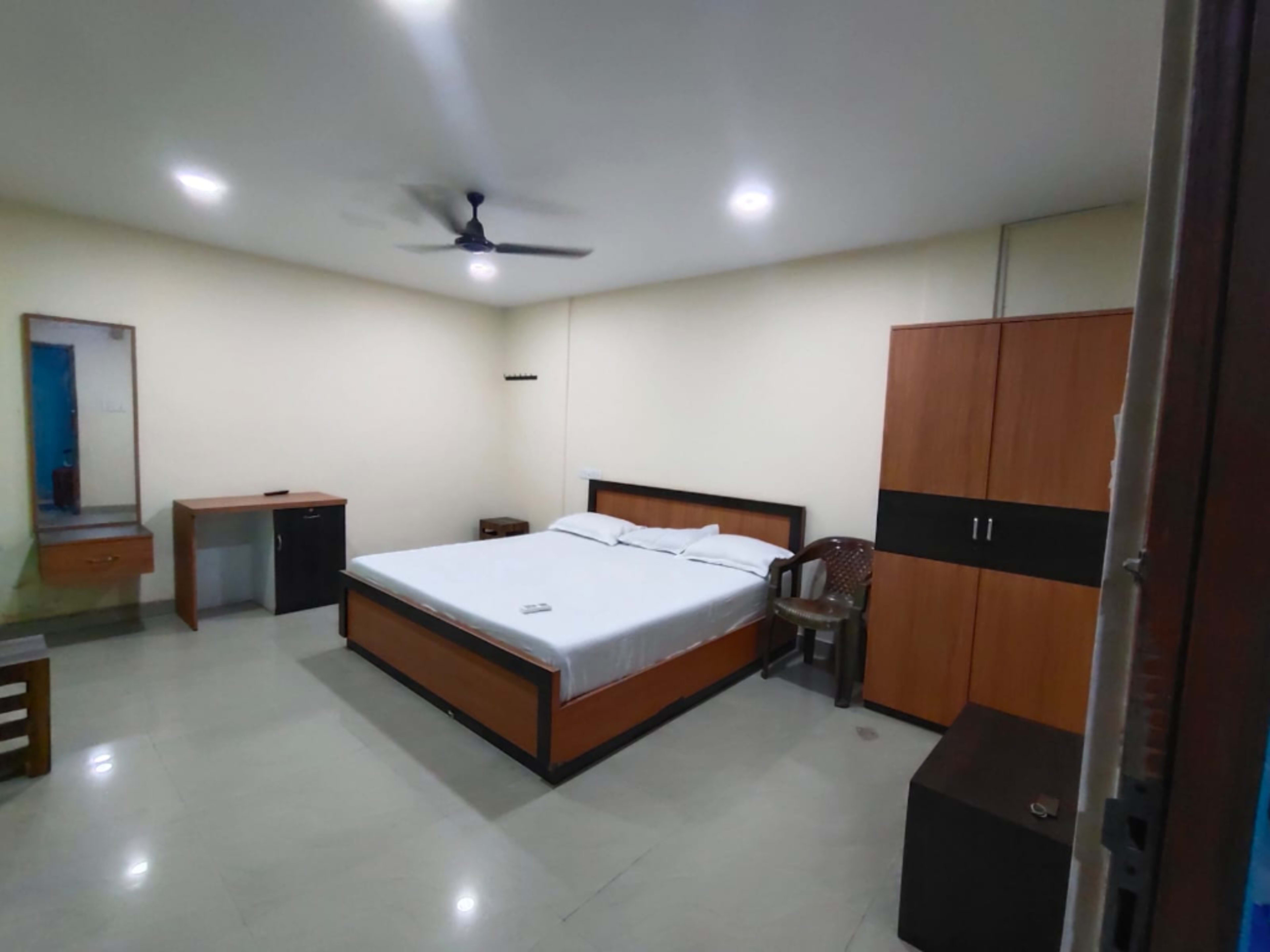 Double bed setup with wardrobe at Hotel Sunrise