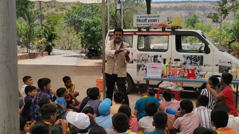 Children doing science experiments outside the van