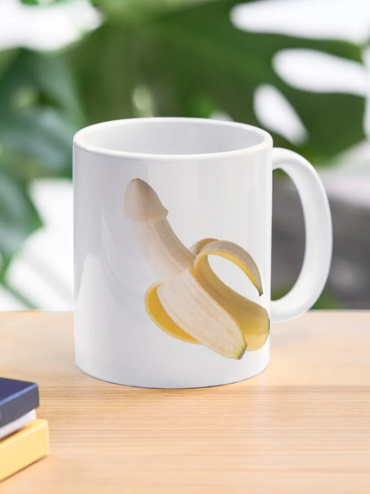 White ceramic mug printed with a peeled banana that looks like a penis.