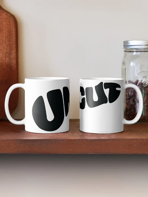 Big black uncut penis form text in a coffee mug.