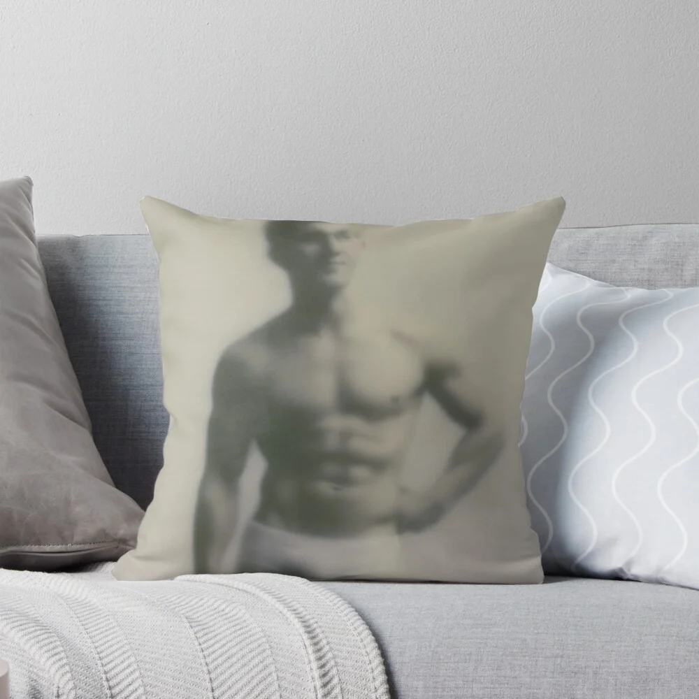 Throw pillow on a couch featuring the blurred muscular male art print