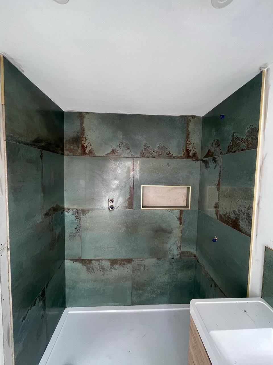 Bathroom installer inspecting hidden problems during a renovation in Derby