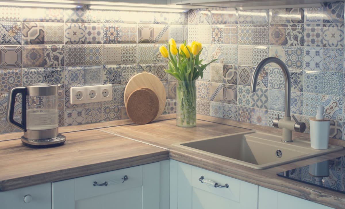 Bright fitted kitchen with sink, tiled splashback and worktop in a Liverpool home