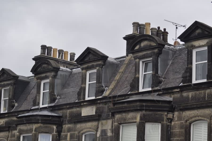 Victorian terrace roofline with chimney stacks and dormer windows in Croydon