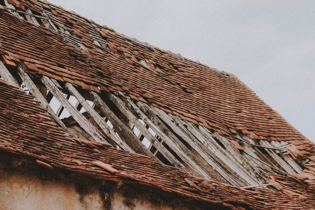 Storm damaged roof with tiles gone and the battens left exposed