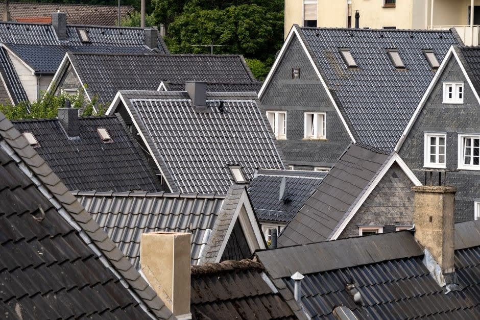 Grey tiled rooftops across a residential neighbourhood of the kind repaired across Southport