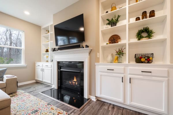 Living room chimney breast with fitted alcove shelving and cabinets