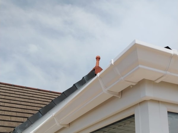 New white fascia, soffit and guttering fitted along a roof edge in Carlisle