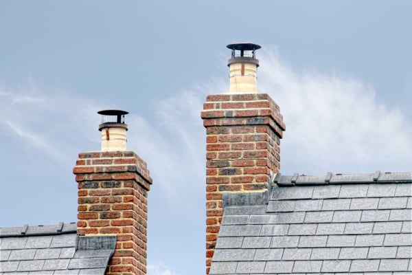Brick chimney stacks and pots on a period property in Carlisle