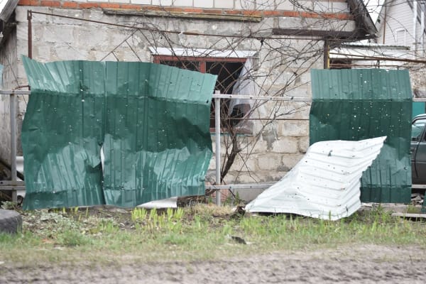 Storm damaged building in the Mansfield area secured under protective sheeting