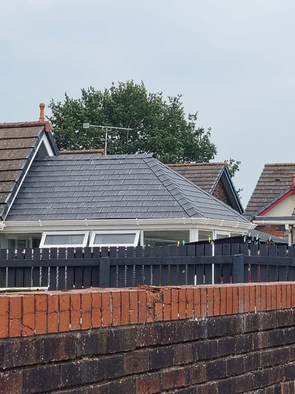Completed hipped roof in dark slate-grey tiles on a Southport bungalow