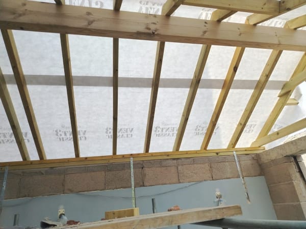 New roof rafters and breathable membrane in place before the covering is laid in Southport
