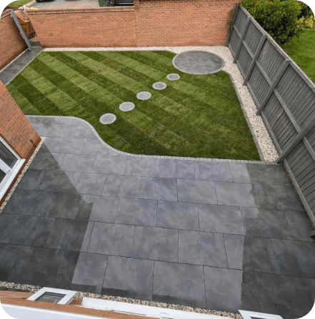 Backyard with gray patio, green lawn with striped mowing, stepping stones, and gravel borders.