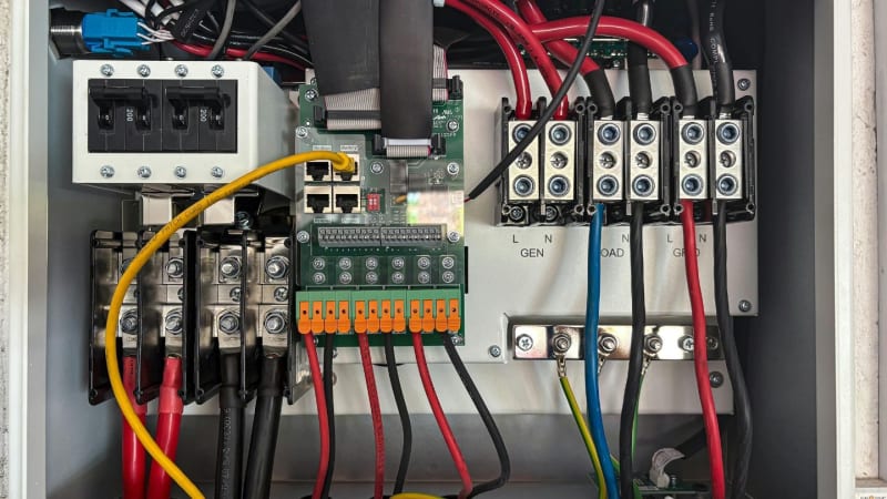 Commercial electrician wiring a distribution board in a Bristol business