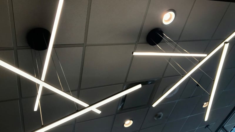 Electrician installing commercial LED lighting in a Bristol business