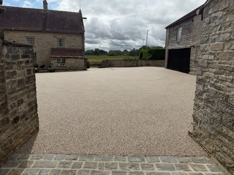 Grey resin driveway with light grey resin and block paving border