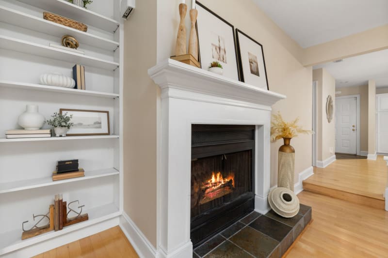Lit fireplace with fitted shelving in the chimney breast alcove