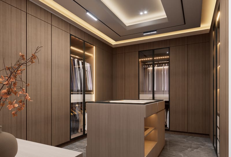 Fitted dressing room with warm lighting and wood-finish wardrobes