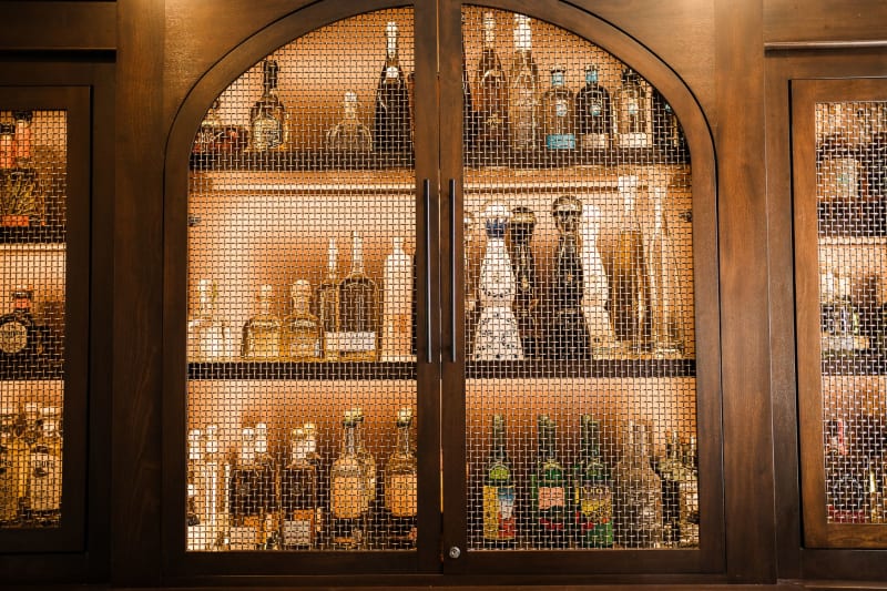 Wooden drinks cabinet with fitted shelving for bottles and glassware