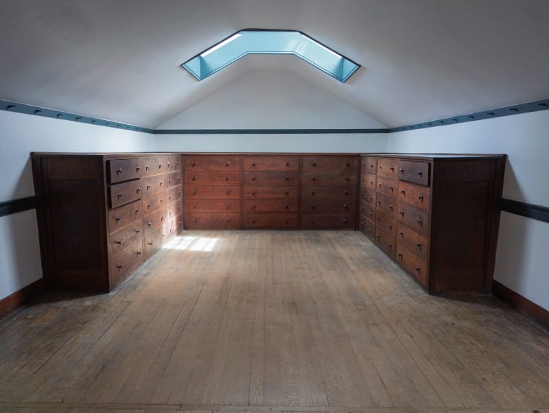 Under-eaves storage drawers beneath a skylight