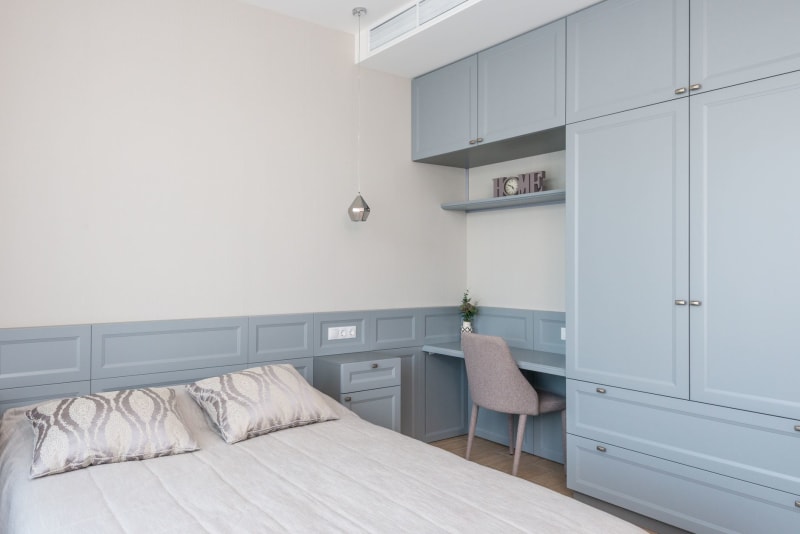 Spare room workspace with built-in cabinetry and desk in soft blue tones