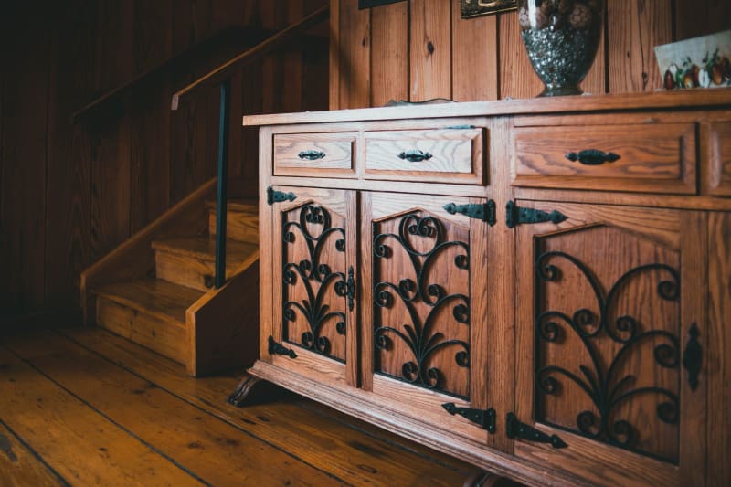 Wooden storage cabinet fitted beside a staircase in a period home