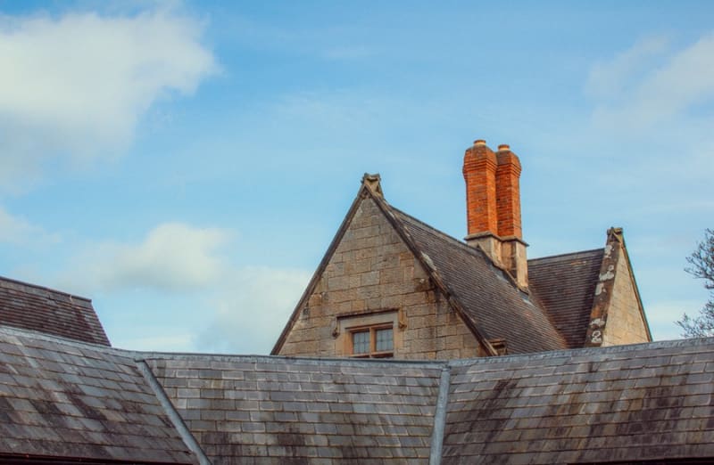 Tall red chimney pots on an older roof in the Croydon area