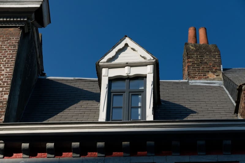 Slate roof, dormer and brick chimney above the eaves of a Mansfield house
