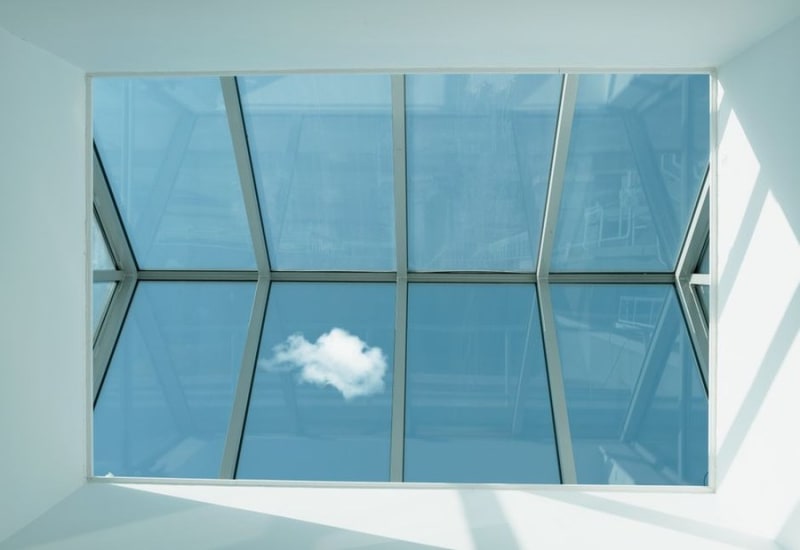 Skylight viewed from below, set into a flat roof against a blue sky