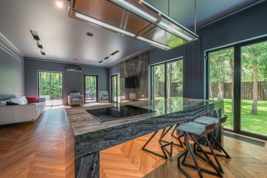 Interior view of aluminium sliding doors leading from kitchen extension to garden