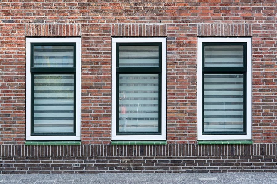 White uPVC replacement windows on a brick house exterior