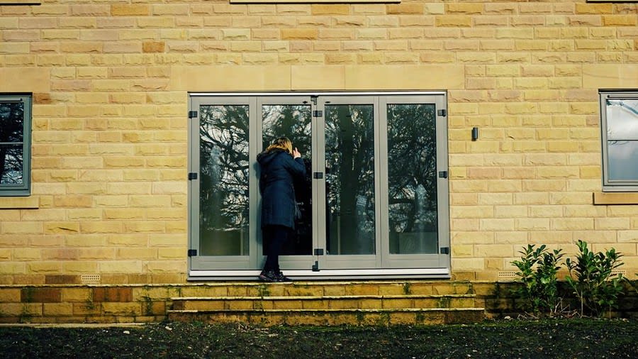 Bi-fold glass doors opening onto garden patio from Exeter home
